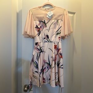 Beautiful pink flower dress, never worn and it still has its original tags.